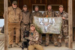 Men of the WWIA wearing camo standing for a group photo