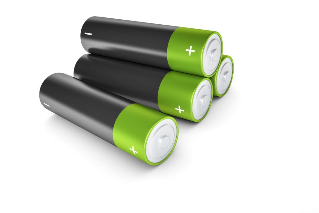 black and green batteries with plus and minus