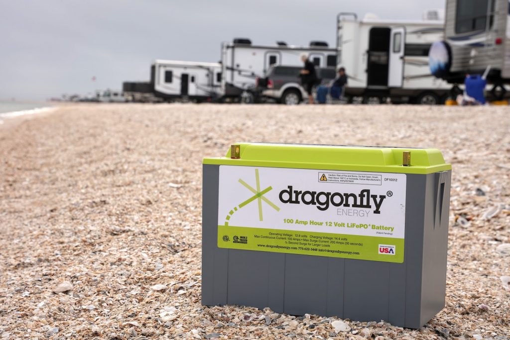 Dragonfly Energy Battery on a beach with RVs in the background