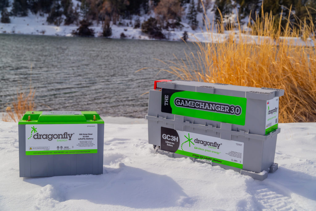 Dragonfly Energy batteries in the snow in front of a lake