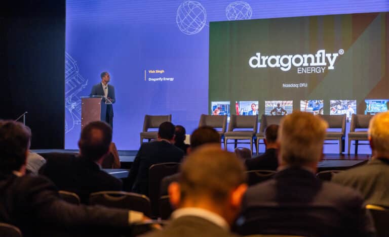 Dr. Vick Singh of Dragonfly Energy delivering a presentation on stage about lithium battery manufacturing and energy innovation.